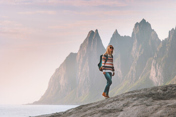 Obraz premium Tourist woman traveling in Norway active lifestyle vacations outdoor Okshornan peaks landscape Senja island
