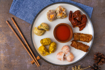 various variants of dim sum in ceramic plates