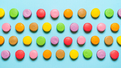 Multi-colored homemade macarons flat lay. Top view with macarons aligned in a row