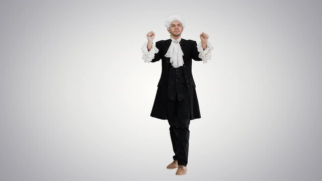 Man dressed like Mozart expressively finishing conducting while looking at camera on gradient background.