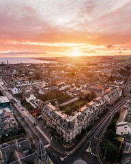 Fototapeta premium Aerial drone shot of St Andrews, Scotland while sunrise