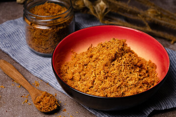 shredded chicken served in a glass jar and read bowl