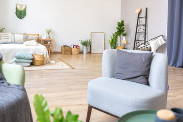 interior of stylish loft. spacious apartment with large windows, parquet on the floor and light walls. closeup view of shelving with different small things for decoration
