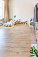 interior of stylish loft. spacious apartment with large windows, parquet on the floor and light walls. closeup view of shelving with different small things for decoration