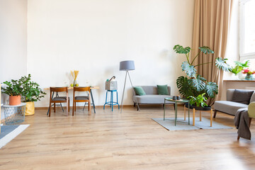 interior of stylish loft. spacious apartment with large windows, parquet on the floor and light walls. closeup view of shelving with different small things for decoration