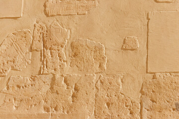 Ancient egyptian paintings and hieroglyphs on a wall in Mortuary temple of Hatshepsut in Luxor,...