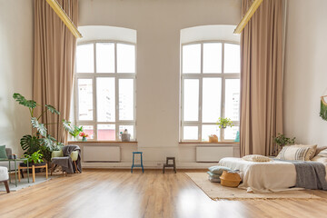 interior of stylish loft. spacious apartment with large windows, parquet on the floor and light...