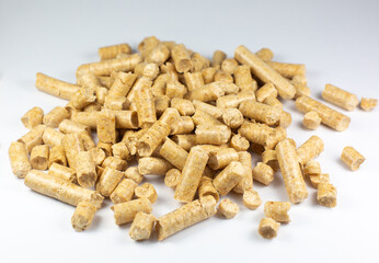 Wood pellets texture. Wooden pet bedding on white background. Close up photo.