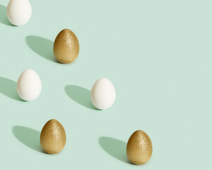 Easter composition with white and golden eggs, creative spring holiday background with painted chicken egg