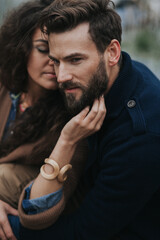 portrait of two caucasian lovers. Young couple is hugging on autumn day outdoors. A bearded man and curly woman in love. Valentine's Day. Concept of love and family.