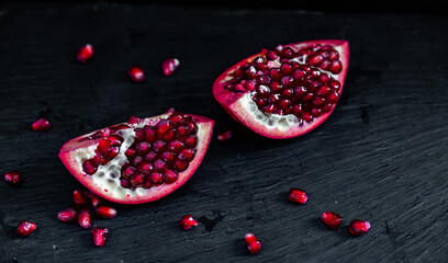 pomegranate pieces on black background