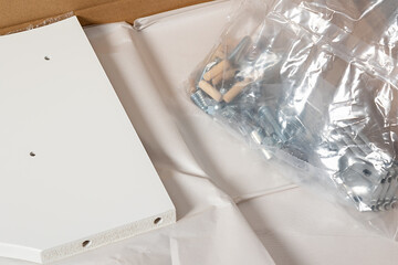 parts for assembling furniture in packaging. Bolts and dowels in a plastic bag
