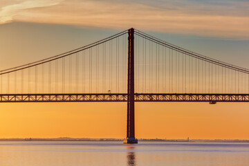 Fototapeta na wymiar 25 de Abril Bridge in Lisbon, Portugal, at sunrise