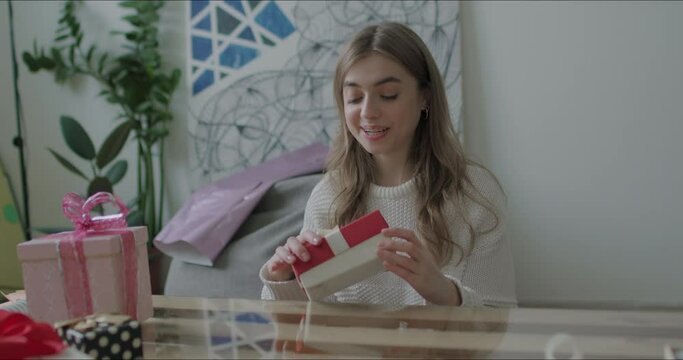 Woman opens present gift
