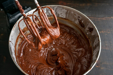 Making Chocolate Frosting in a Stand Mixer: Chocolate cake icing that has just been made in an electric stand mixer