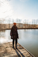 young woman on the pier near the winter lake