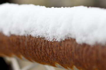 snow on a rusty rail selective focus
