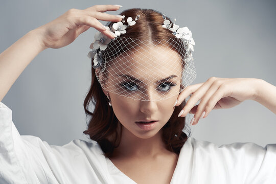 Portrait of a bride with birdcage veil.