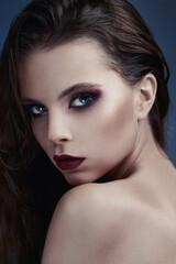 Fototapeta premium Face of a beautiful girl with smoky eyes makeup.