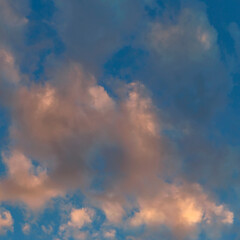 Fototapeta na wymiar Beautiful sunlit golden clouds in the evening sky