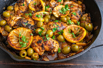 Moroccan Lemon Olive Chicken: Chicken thighs, olives, and lemons cooked in a cast iron skillet