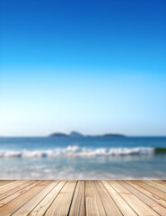 Obraz premium Empty stage for products. Blurred sea background with wood resort deck floor in foreground. Image of Ipanema beach in Rio de Janeiro, Brazil.