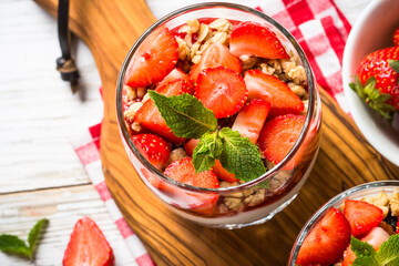 Greek yogurt with fresh strawberry and granola. Top view with copy space.