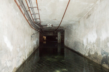Abandoned building interior - cellar corridor full with water