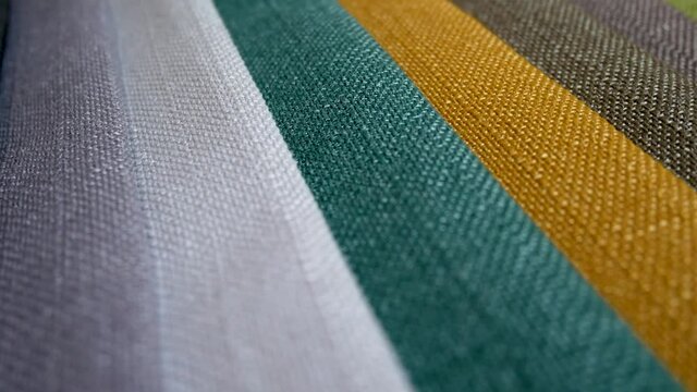 Colorful fashion fabric samples. Textile textures swatches concept. Woven fabric is any textile formed by weaving. Different colors. Clothes texture closeup