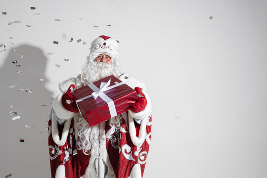 santa claus with long white beard with a gift in his hands, picture isolated on white background