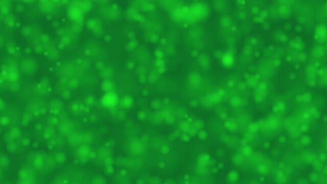 Bokeh bright green dreamy background with shiny glowing circle which are approaching like champagne bubble. For celebrating winter Holidays and Saint Patrick Day concept backdrop 4k with copy space