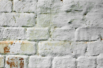 Texture of a brick wall with cracks and scratches which can be used as a background