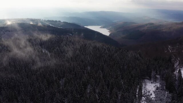 the obernau dam in germany with the rothaar mountains in winter