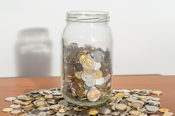 Polish coins money jar on a pile of coins.