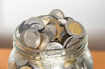 Close-up on polish coins in glass jar.