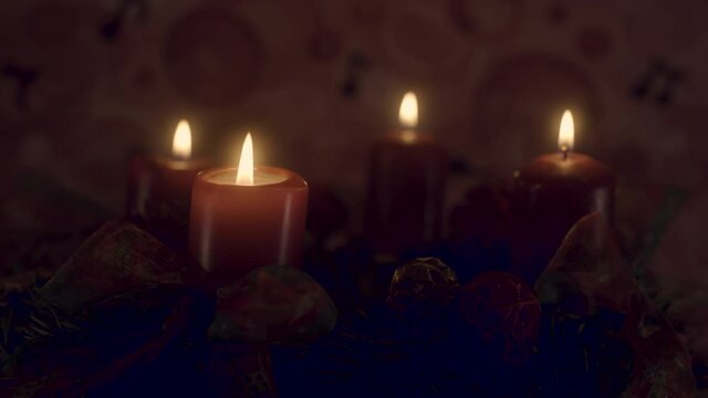 Closeup of an advent wreath with four candles burning, then extinguished