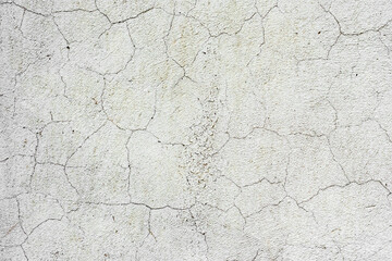 Texture of a concrete wall with cracks and scratches which can be used as a background