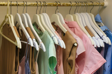 hangers with women's dresses and other colorful clothes