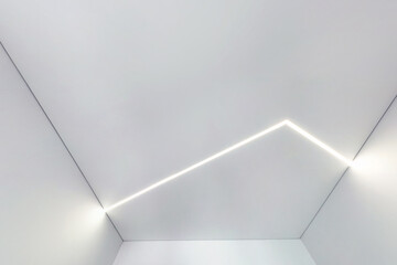 suspended ceiling with halogen spots lamps and drywall construction in empty room in apartment or...