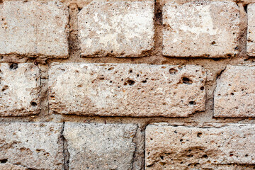 Texture of a brick wall with cracks and scratches which can be used as a background