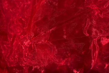 crumpled fabric in deep red color - close up, decor and exclusive textured fabric background, holidays and event backdrop
