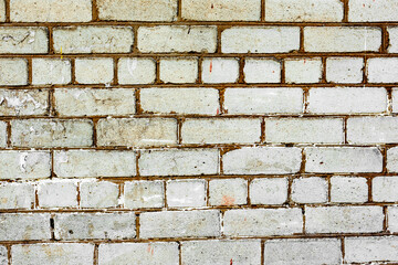 Texture of a brick wall with cracks and scratches which can be used as a background