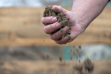Sifting and pouring sand. Sifting with hands and pouring dirt and sand at field