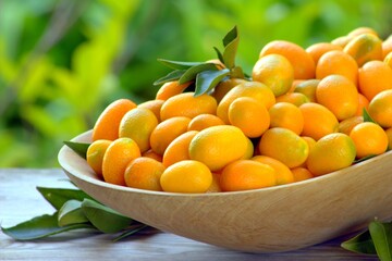 Fresh kumquats in a dish. Citrus background. 

