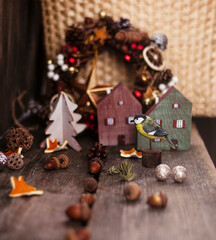 new year and christmas background. miniature wooden tit,wooden toy houses and christmas tree .backgrounds for greeting cards