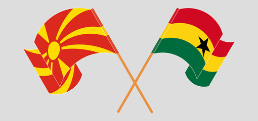 Crossed and waving flags of North Macedonia and Ghana