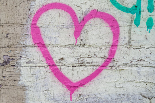 Pink heart on the Brick wall background