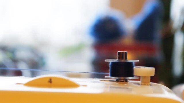 Winding the thread on the coil on the sewing machine. High quality FullHD footage