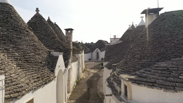 Alberobello, Italy. Aerial footage of the narrow street within traditional built. Views of the whole districts containing dense concentrations of trulli. High quality 4k footage