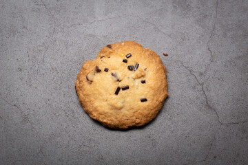 Circle tasty homemade chocolate cookie artisan made on a grey background